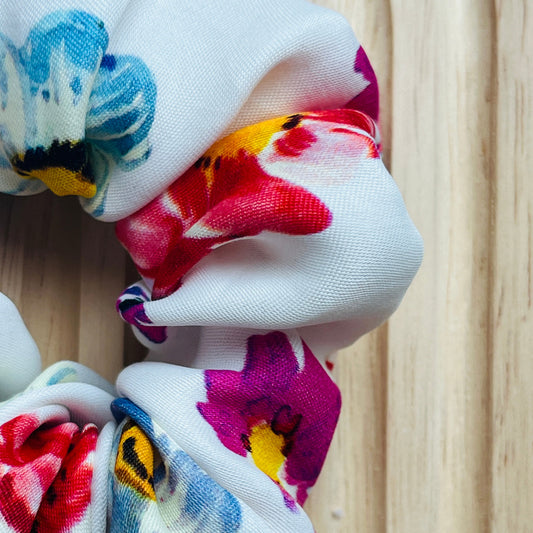 Haar scrunchie van satijn katoen in wit met bloemenpatroon. Elastisch en geschikt om een staart of knot vast te maken. Handgemaakt door Studio Dwarsdenker