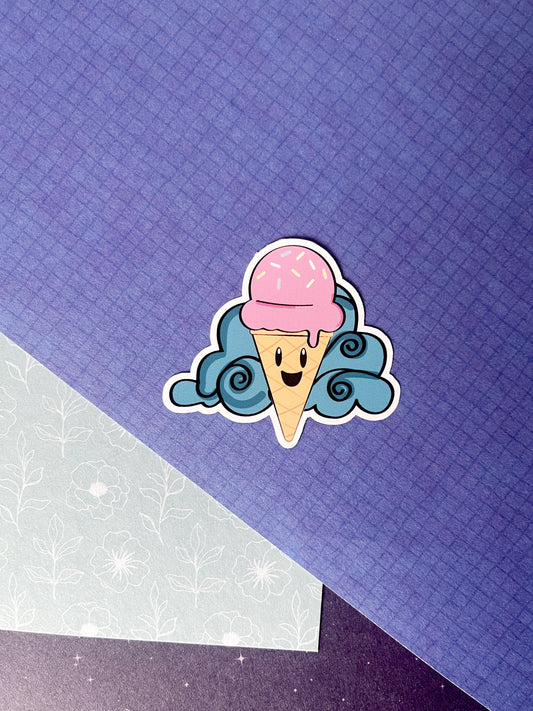 Sticker in zomers thema. Bestaande uit een roze ijsje met lachend gezichtje en een wolkje op de achtergrond. kleuren; blauw, geel, roze, bruin. Ontwerp door Studio Dwarsdenker
